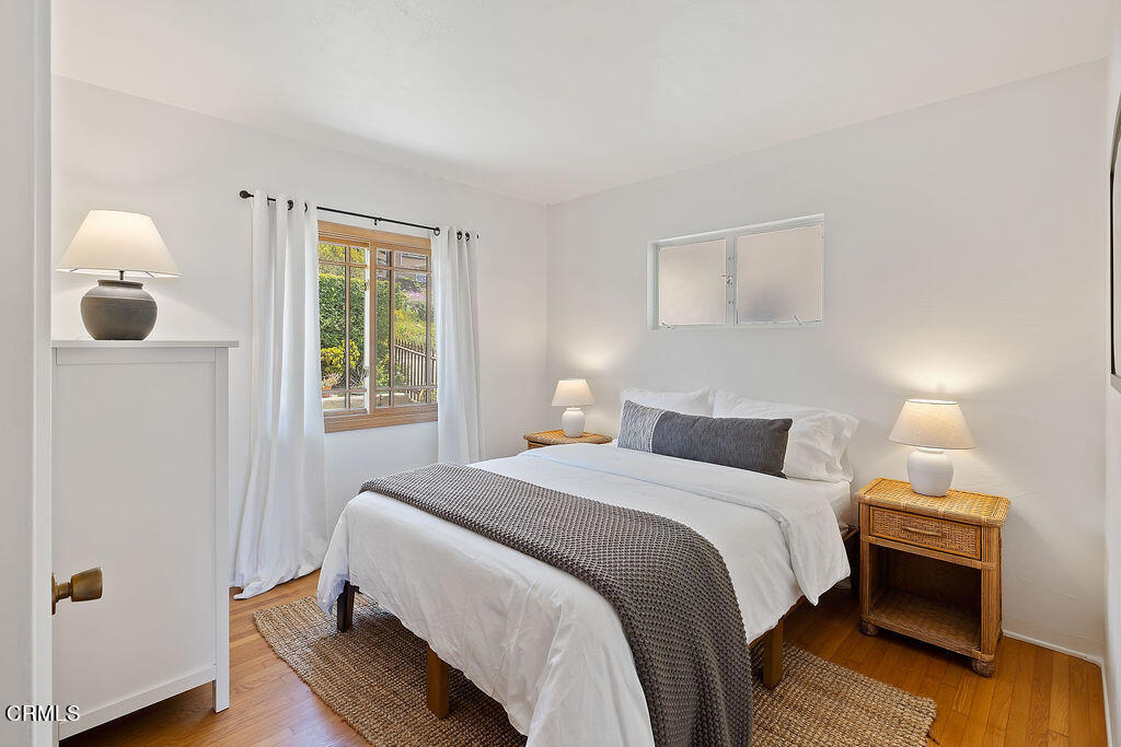 2335 Whitney Avenue Summerland, CA 93067 - Photo 24 of 33 a bedroom with a bed and wooden floor