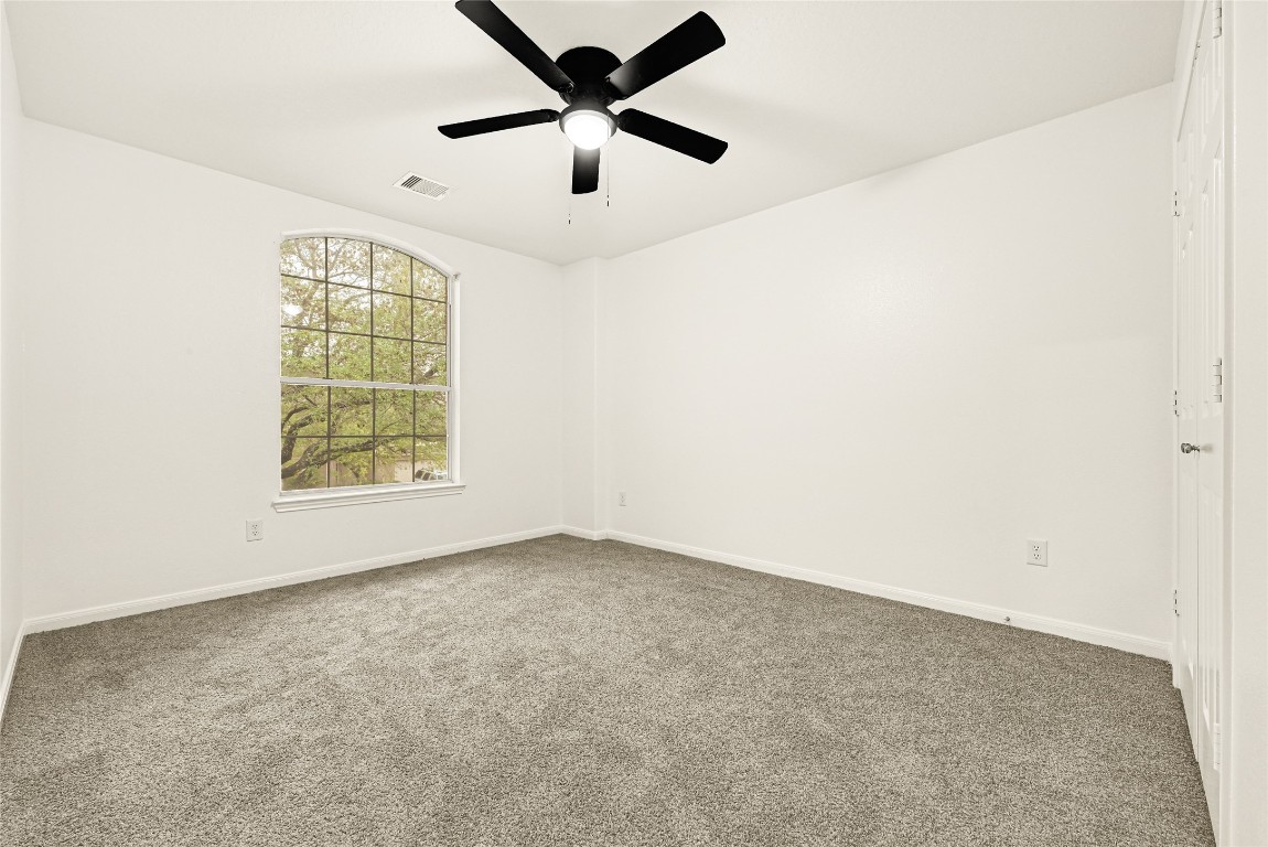 1914 Rock Ridge Drive Houston, TX 77049 - Photo 12 of 26 an empty room with windows and fan
