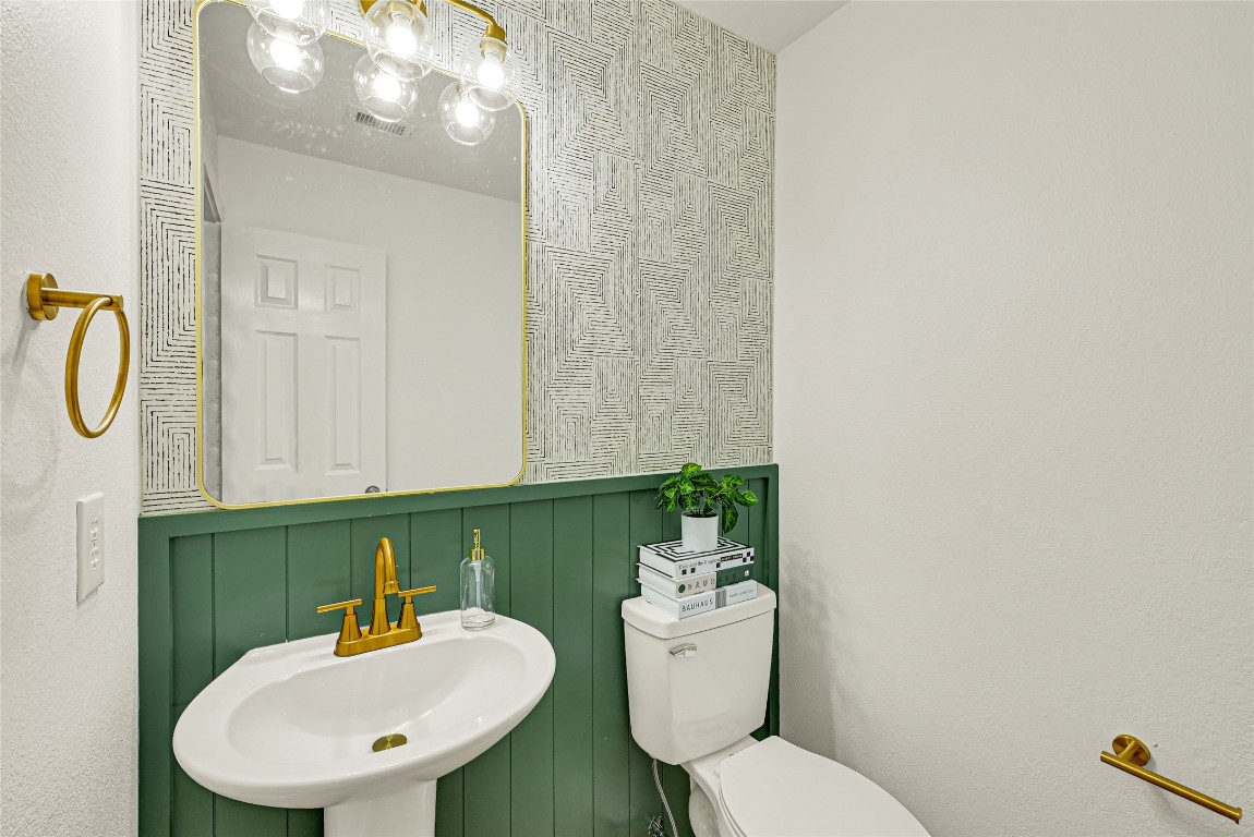 1914 Rock Ridge Drive Houston, TX 77049 - Photo 19 of 26 a bathroom with a toilet sink and mirror