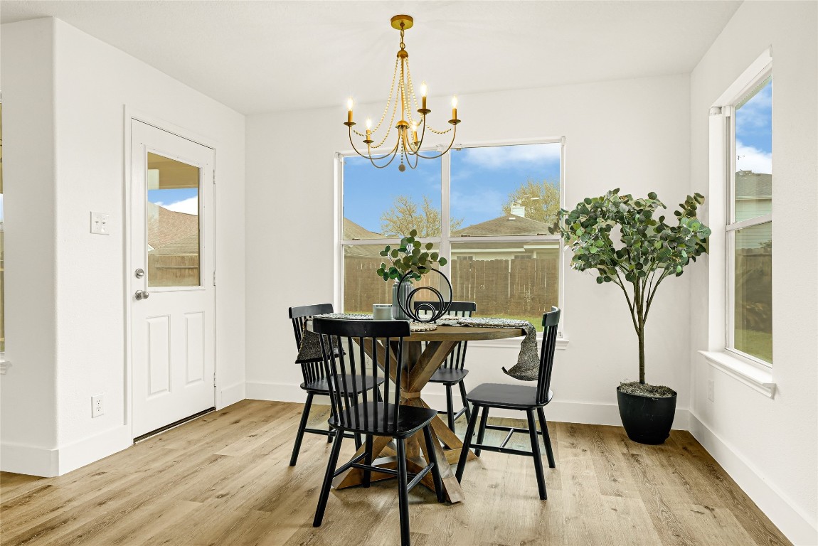1914 Rock Ridge Drive Houston, TX 77049 - Photo 20 of 26 a view of a dining room with furniture wooden floor and chandelier