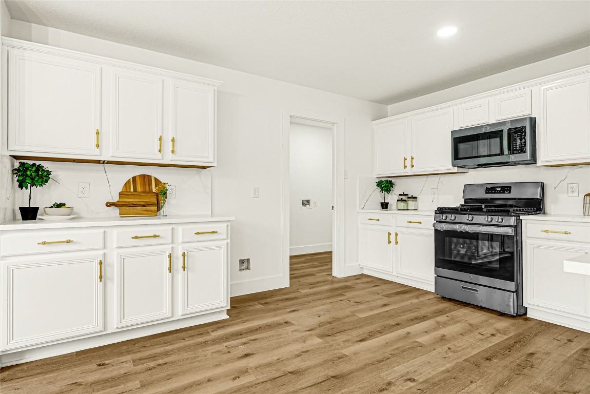 1914 Rock Ridge Drive Houston, TX 77049 - Photo 22 of 26 a kitchen with stainless steel appliances granite countertop a stove a sink and a refrigerator