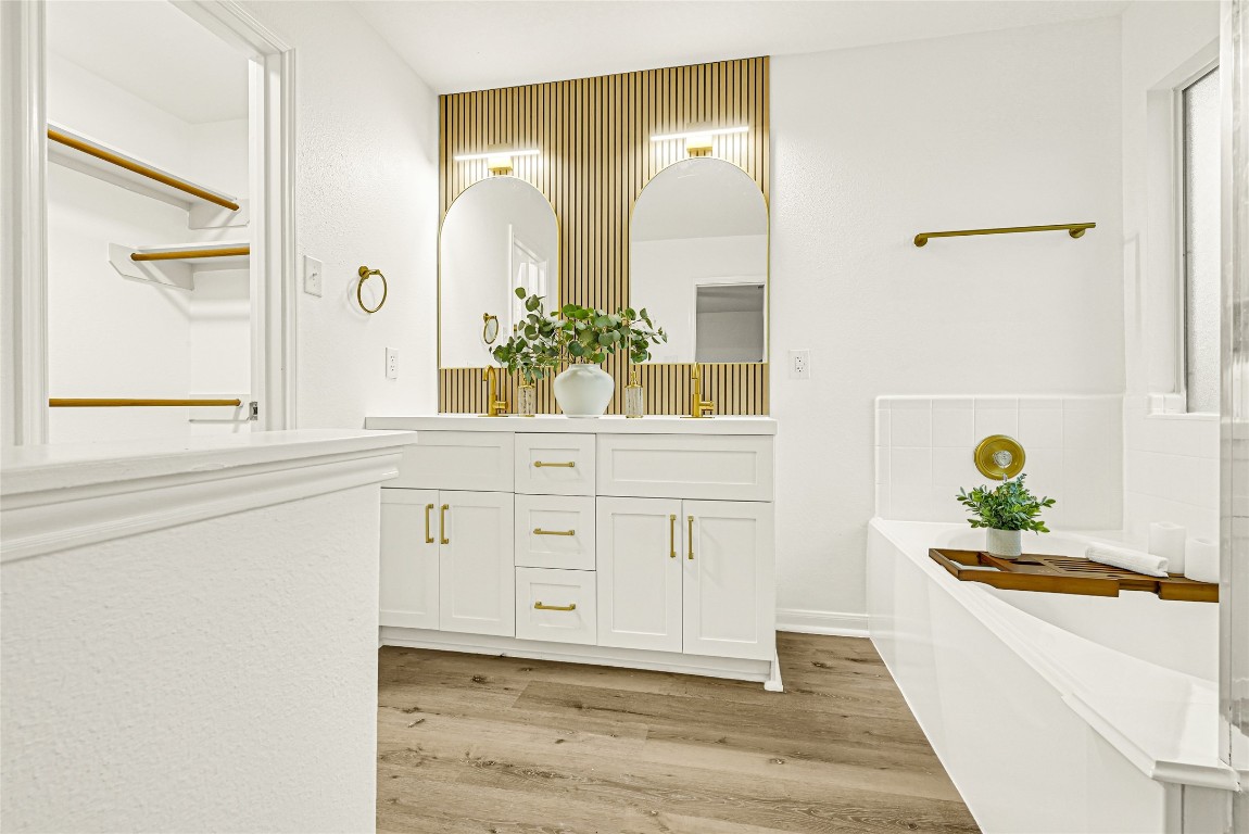 1914 Rock Ridge Drive Houston, TX 77049 - Photo 3 of 26 a hallway with white cabinets and wooden floor