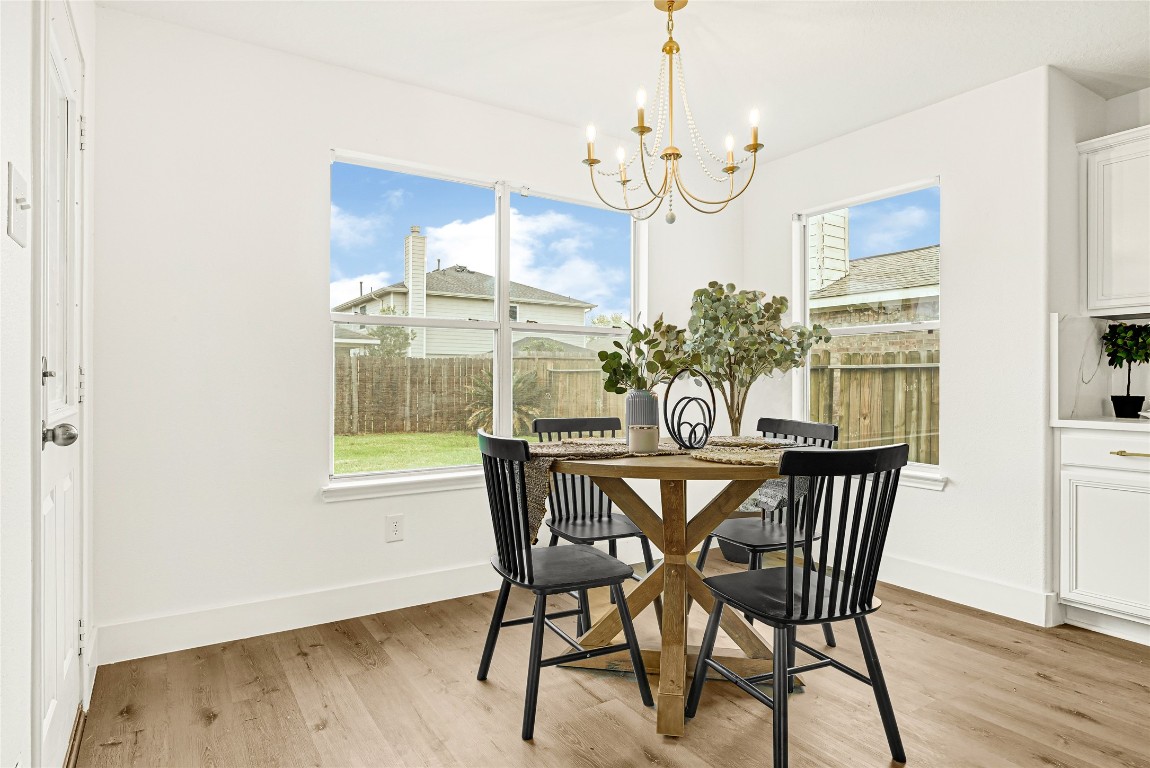 1914 Rock Ridge Drive Houston, TX 77049 - Photo 6 of 26 a view of a dining room with furniture wooden floor and chandelier