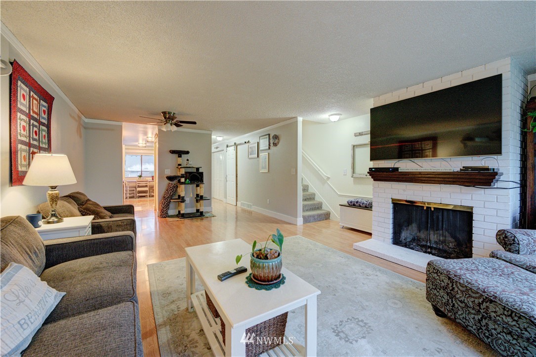 21515 4th Avenue West, Unit A72 Bothell, WA 98021 - Photo 11 of 36 a living room with furniture a flat screen tv and a fireplace