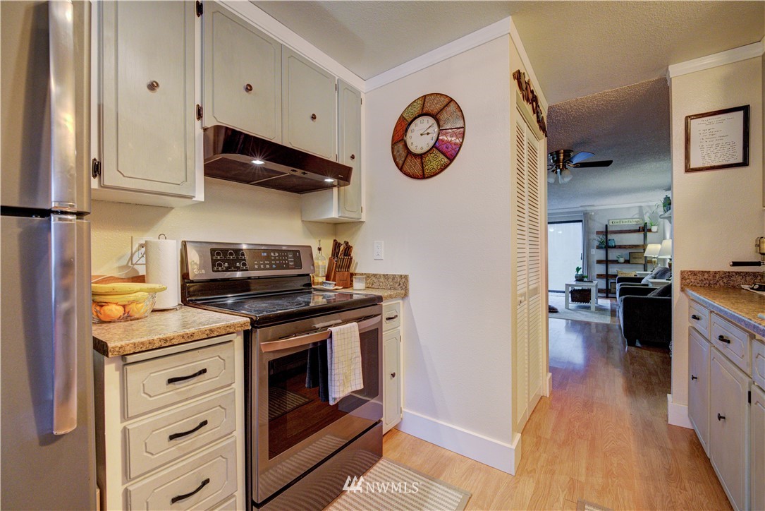 21515 4th Avenue West, Unit A72 Bothell, WA 98021 - Photo 14 of 36 a kitchen with stainless steel appliances granite countertop a stove and a refrigerator