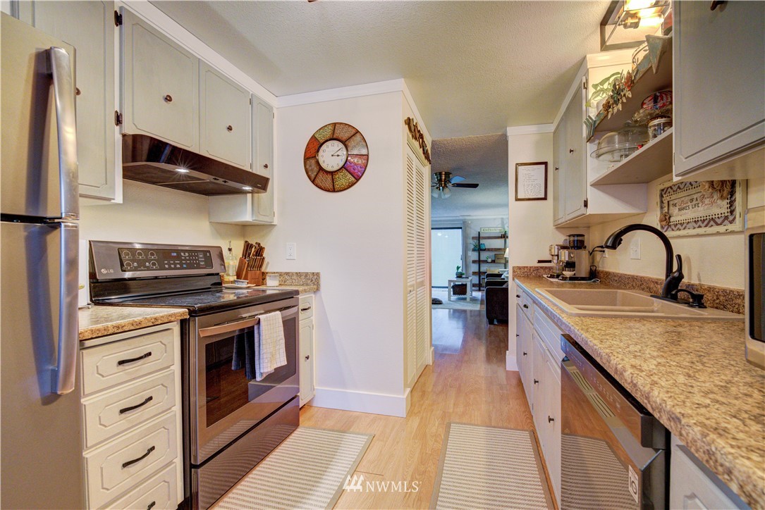 21515 4th Avenue West, Unit A72 Bothell, WA 98021 - Photo 15 of 36 a kitchen with stainless steel appliances granite countertop a stove and a sink
