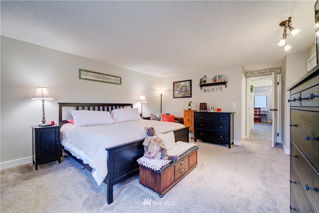 21515 4th Avenue West, Unit A72 Bothell, WA 98021 - Photo 21 of 36 a spacious bedroom with a bed and a flat tv screen on dresser