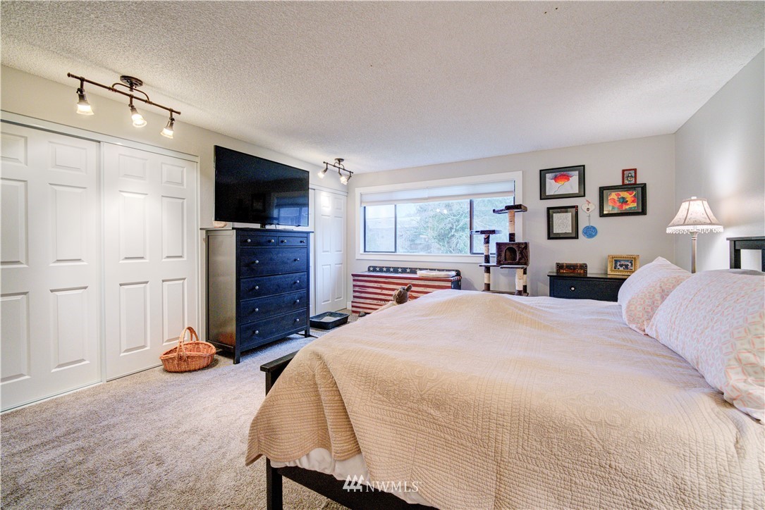 21515 4th Avenue West, Unit A72 Bothell, WA 98021 - Photo 23 of 36 a bedroom with a bed and a flat screen television