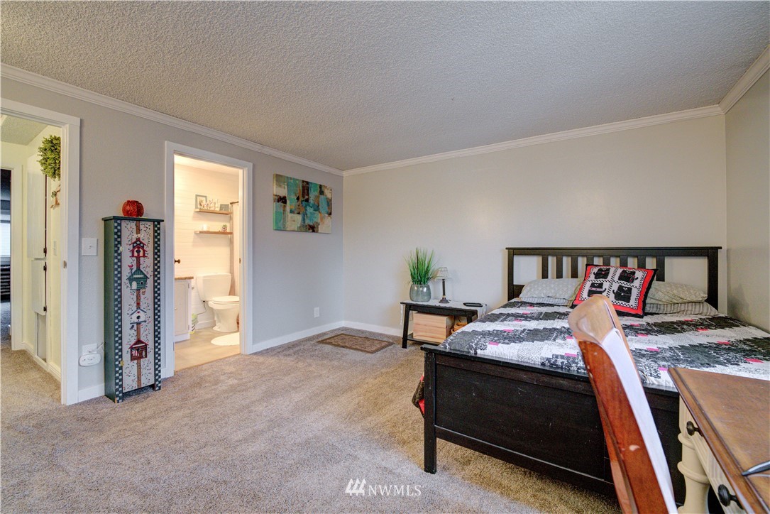 21515 4th Avenue West, Unit A72 Bothell, WA 98021 - Photo 33 of 36 a bedroom with a bed and a table in it