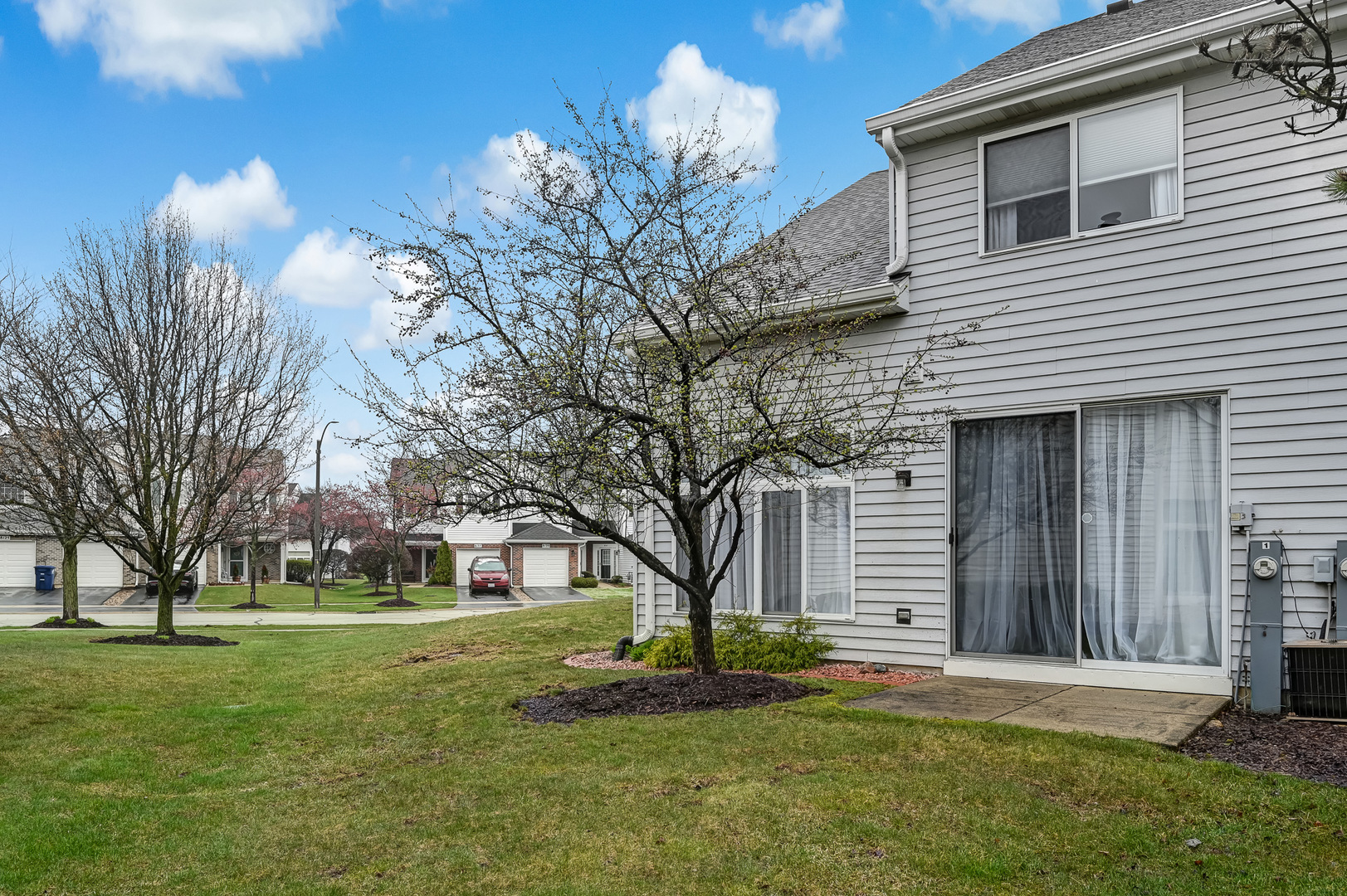 8150 Ripple Ridge Darien, IL 60561 - Photo 13 of 14 a front view of a house with a garden and trees