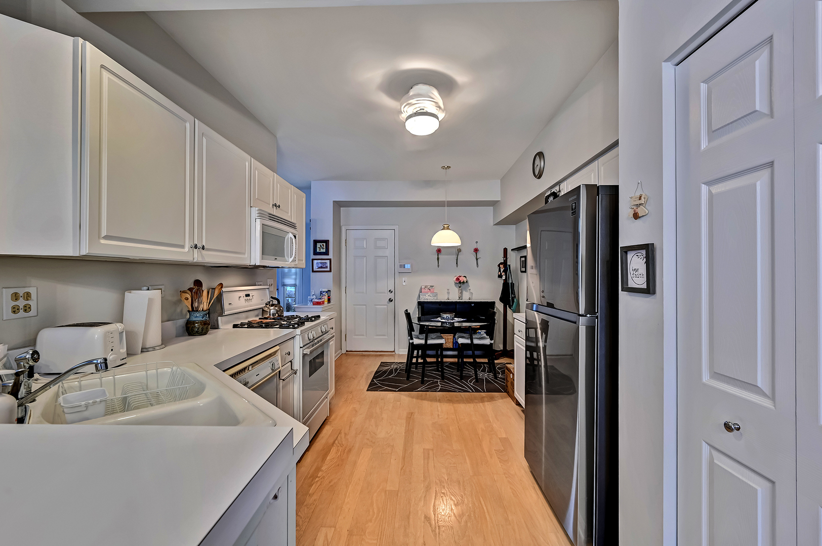 8150 Ripple Ridge Darien, IL 60561 - Photo 2 of 14 a kitchen with stainless steel appliances a refrigerator sink and cabinets