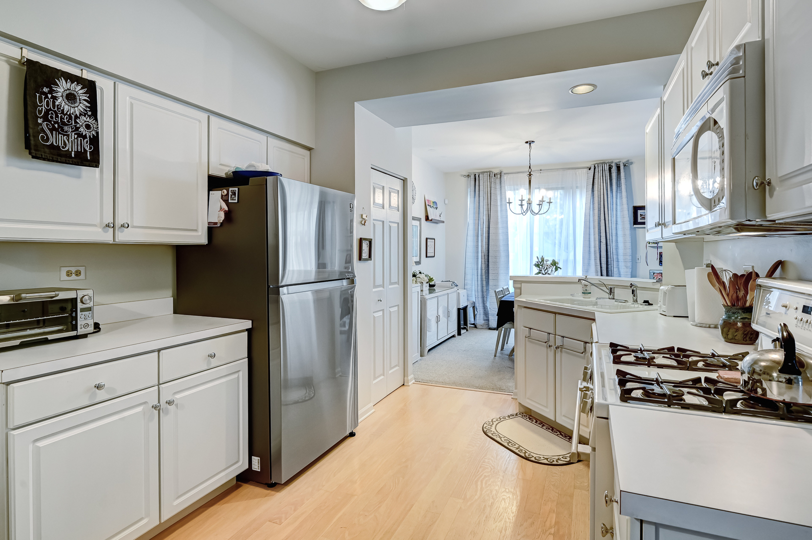 8150 Ripple Ridge Darien, IL 60561 - Photo 3 of 14 a kitchen with granite countertop a refrigerator stove and sink