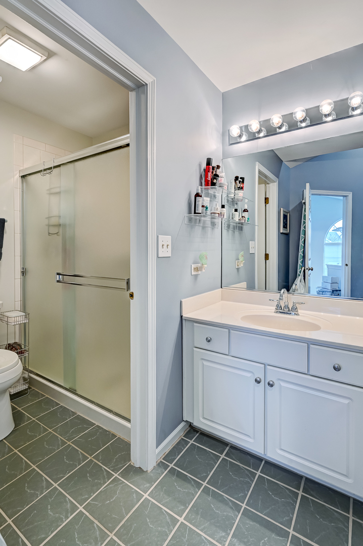 8150 Ripple Ridge Darien, IL 60561 - Photo 8 of 14 a bathroom with a double vanity sink mirror and shower