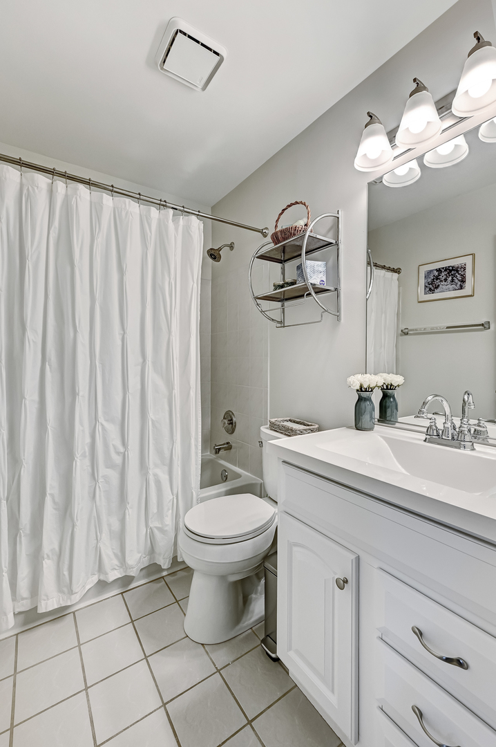 8150 Ripple Ridge Darien, IL 60561 - Photo 9 of 14 a bathroom with a toilet a sink and mirror