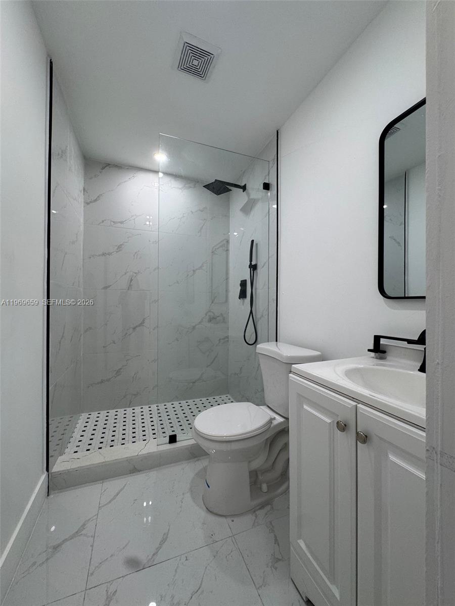 4028 Southwest 11th Street, Unit 4B Miami, FL 33134 - Photo 7 of 10 a bathroom with a sink toilet and shower