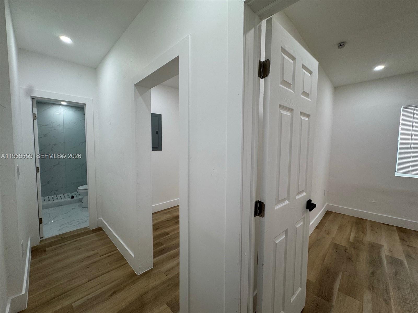 4028 Southwest 11th Street, Unit 4B Miami, FL 33134 - Photo 9 of 10 a view of a hallway with wooden floor and a bathroom