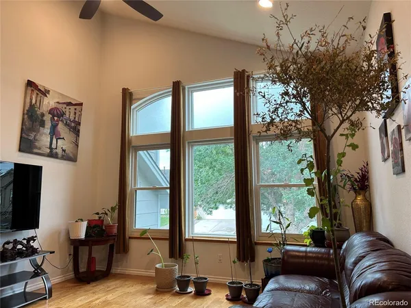 a living room with furniture and large window