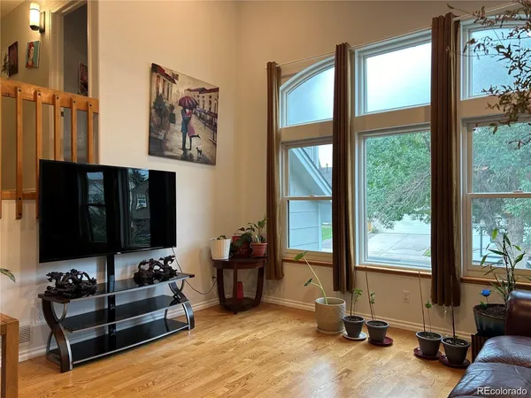 a living room with furniture gym equipment and a large window