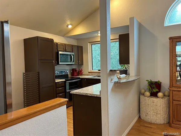 a kitchen with a sink a counter top space and a large window
