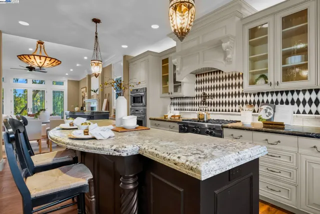 a kitchen with a table chairs and a chandelier