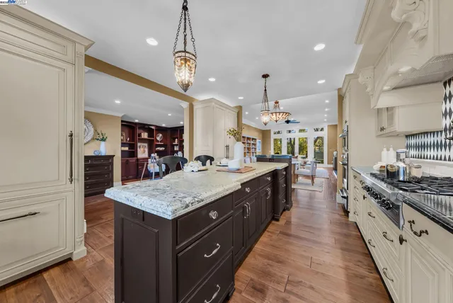 a large kitchen with stainless steel appliances lots of counter space and a sink