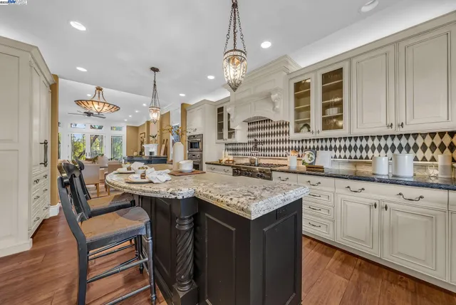 a kitchen with center island white cabinets and sink