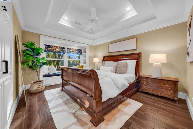 a bedroom with furniture and a potted plant