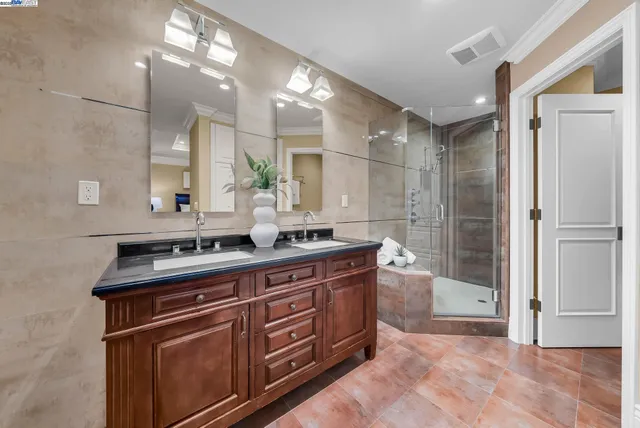 a bathroom with a granite countertop sink mirror and double