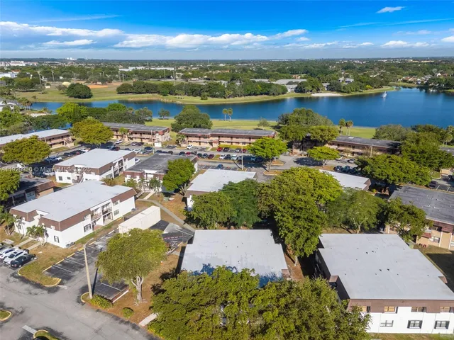 an aerial view of residential houses with outdoor space and ocean view