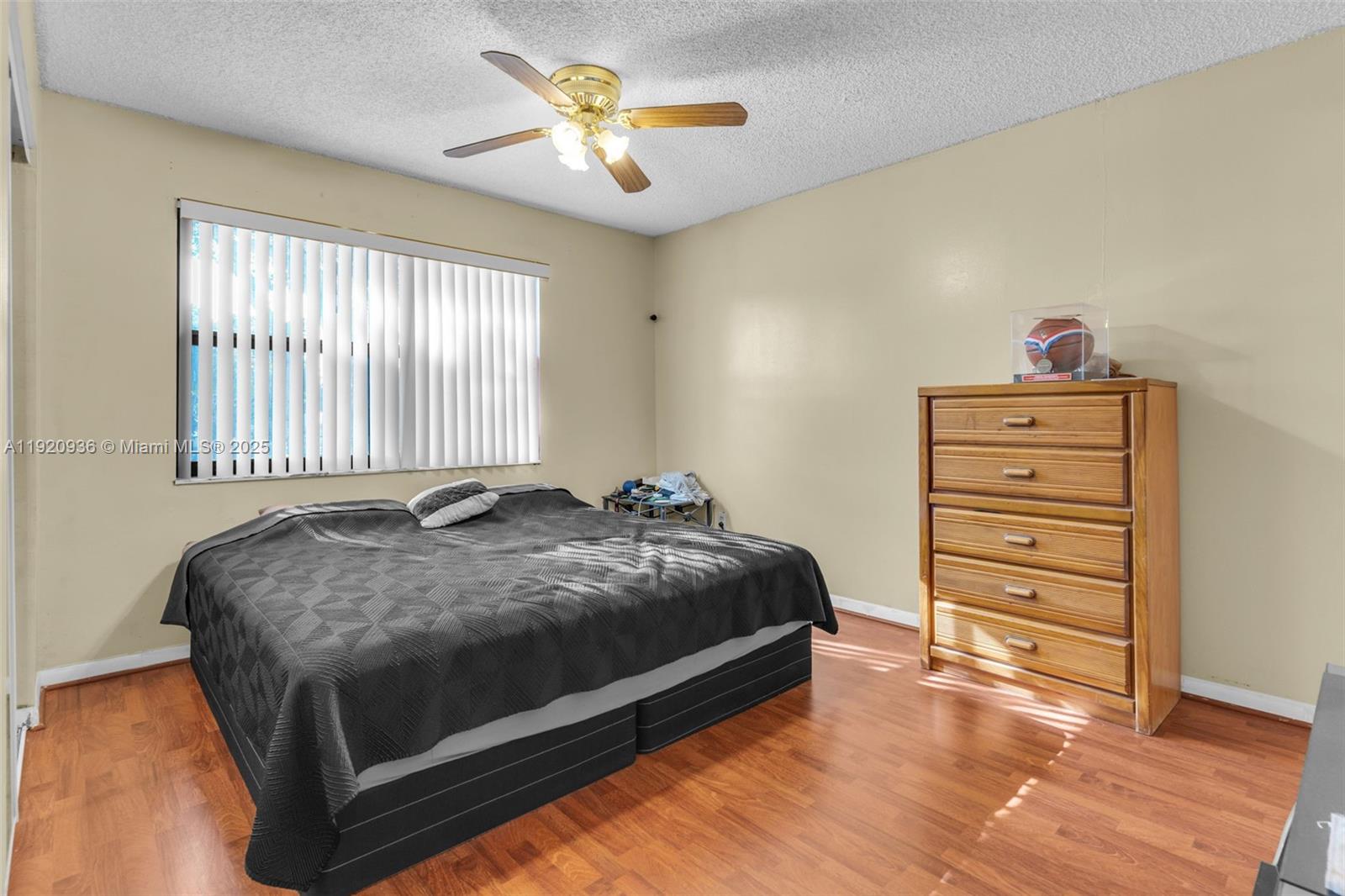 14865 Southwest 104th Street, Unit 2622 Miami, FL 33196 - Photo 16 of 24 a bed sitting in a bedroom next to a window