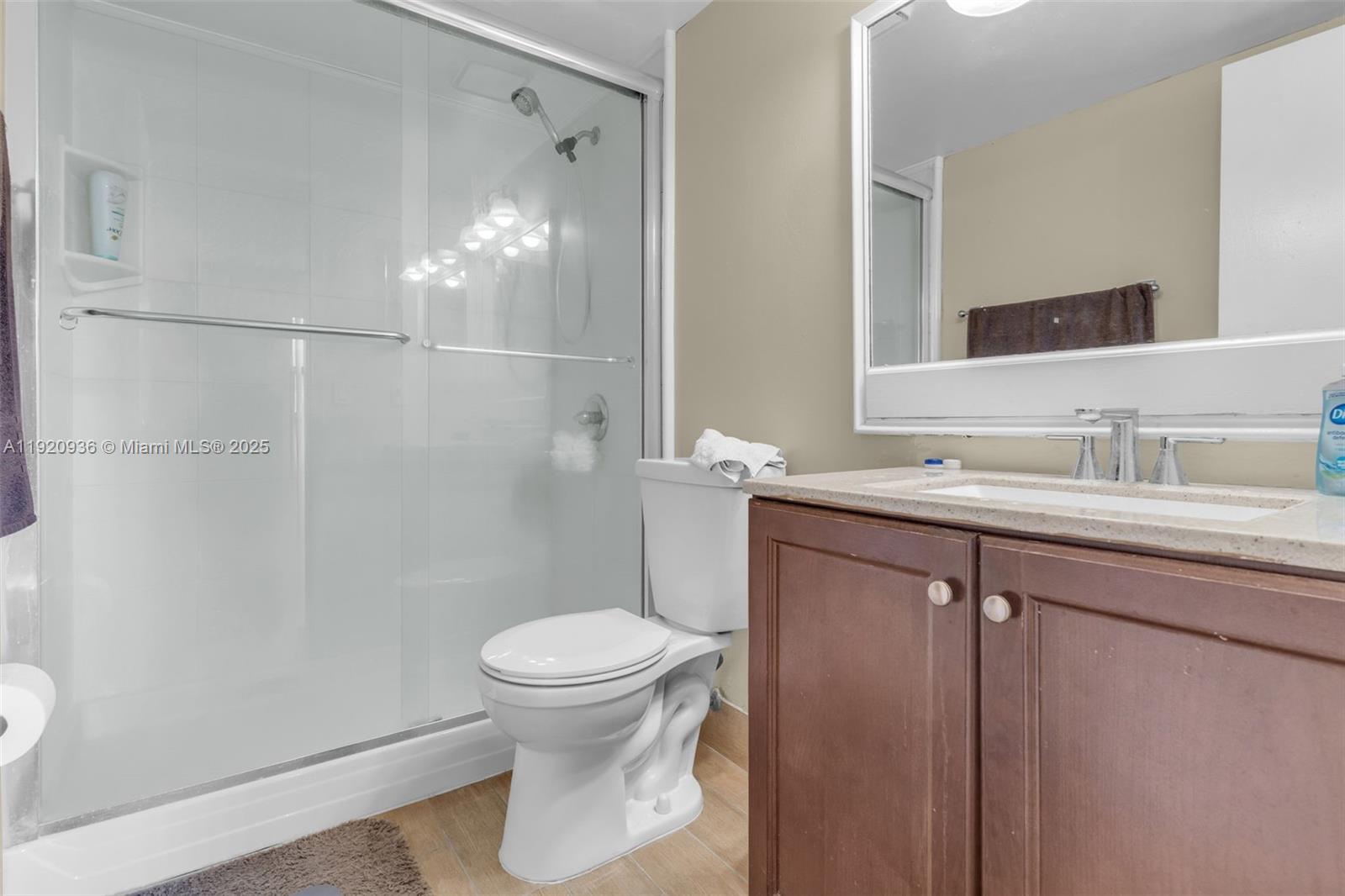 14865 Southwest 104th Street, Unit 2622 Miami, FL 33196 - Photo 18 of 24 a bathroom with a sink a toilet and shower