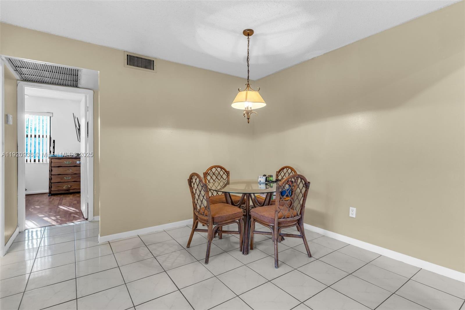 14865 Southwest 104th Street, Unit 2622 Miami, FL 33196 - Photo 6 of 24 a dining room with furniture and chandelier