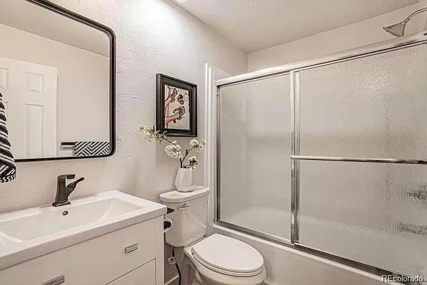 a white toilet sitting next to a bathroom sink