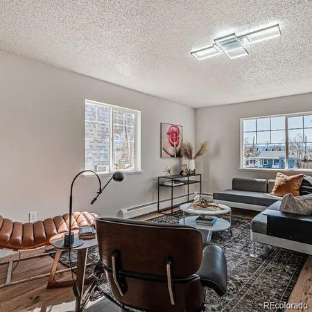 a living room with furniture a rug and a window