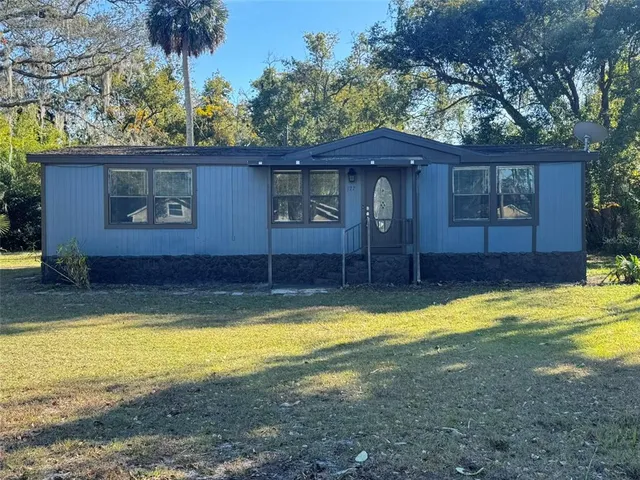 a view of a house with swimming pool and a yard