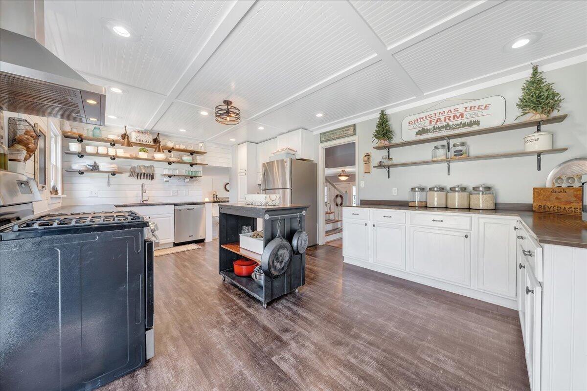 123 Bartley Drive Salem, VA 24153 - Photo 10 of 57 a kitchen with stainless steel appliances kitchen island granite countertop a refrigerator a stove and a sink with cabinets