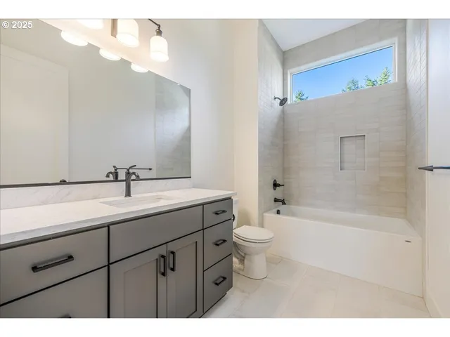 a bathroom with a double vanity sink toilet and shower