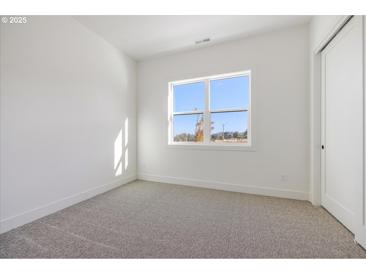 7168 Southeast Eola Hills Road Amity, OR 97101 - Photo 19 of 34 a view of an empty room with a window