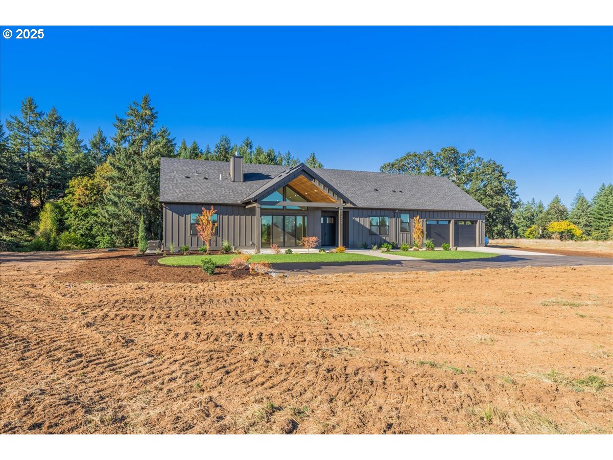 7168 Southeast Eola Hills Road Amity, OR 97101 - Photo 2 of 34 a front view of a house with a garden