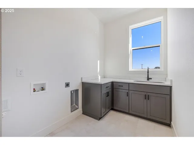 a kitchen with sink and cabinets