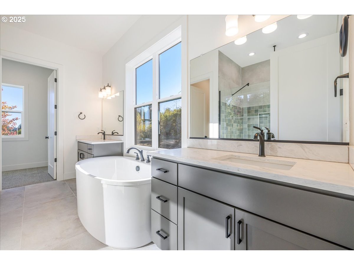 7168 Southeast Eola Hills Road Amity, OR 97101 - Photo 25 of 34 a spacious bathroom with a sink a mirror and a bathtub