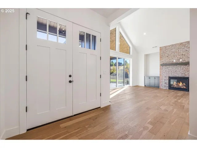 a view of an empty room with a fireplace and a window