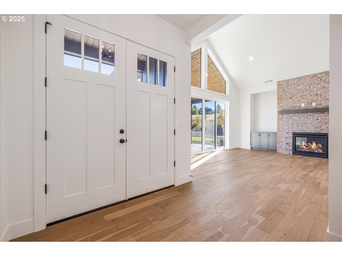 7168 Southeast Eola Hills Road Amity, OR 97101 - Photo 5 of 34 a view of an empty room with a fireplace and a window