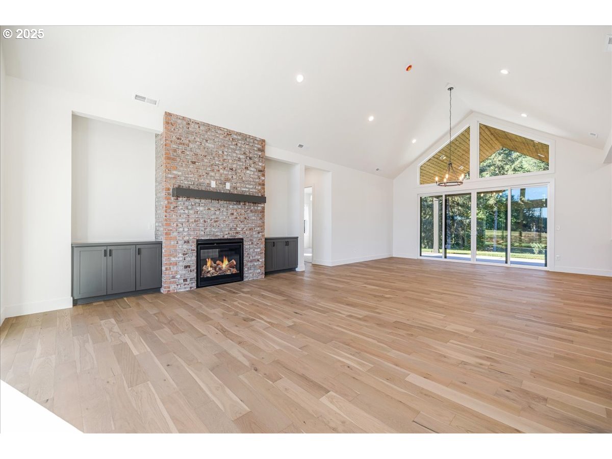 7168 Southeast Eola Hills Road Amity, OR 97101 - Photo 7 of 34 a view of an empty room with wooden floor and a window