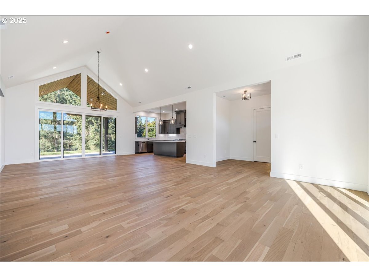 7168 Southeast Eola Hills Road Amity, OR 97101 - Photo 8 of 34 a view of an empty room with wooden floor and a window