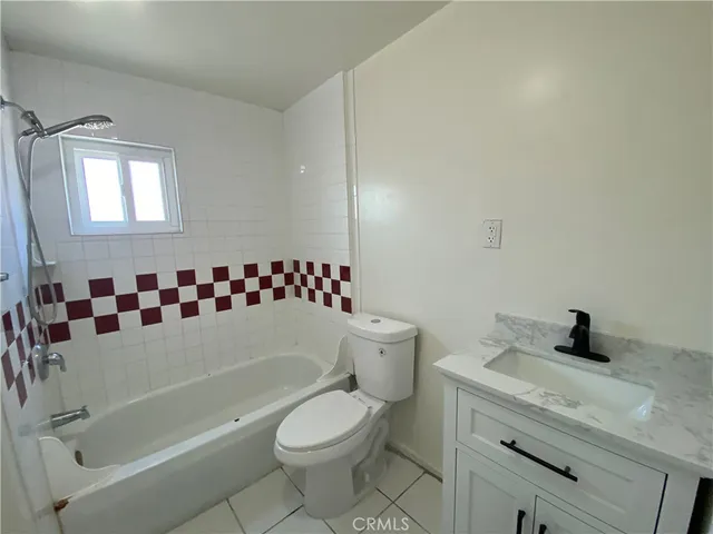 a bathroom with a sink a toilet and a bathtub