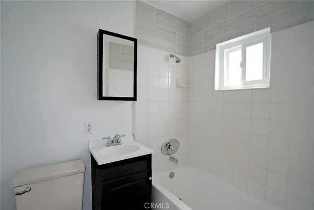 a bathroom with a sink toilet and vanity