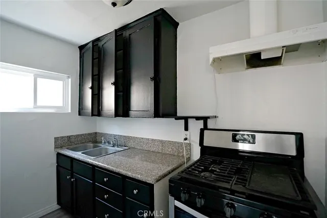 a kitchen with a stove and a sink