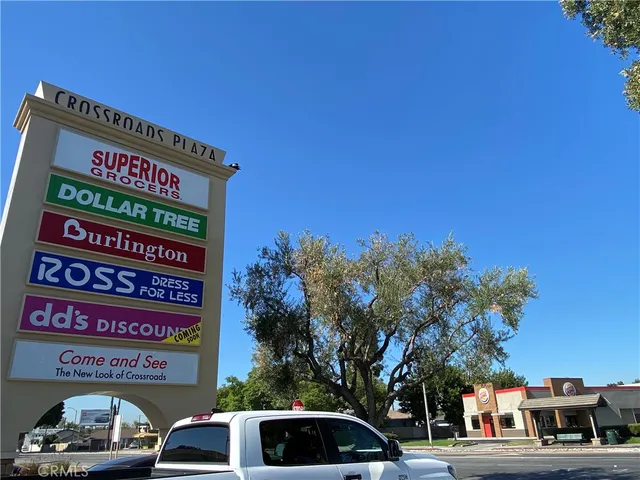 a view of a street with cars parked on the roadside
