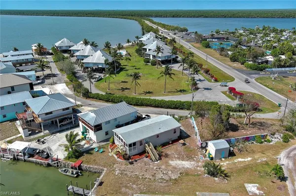 an aerial view of a house with a garden and lake view